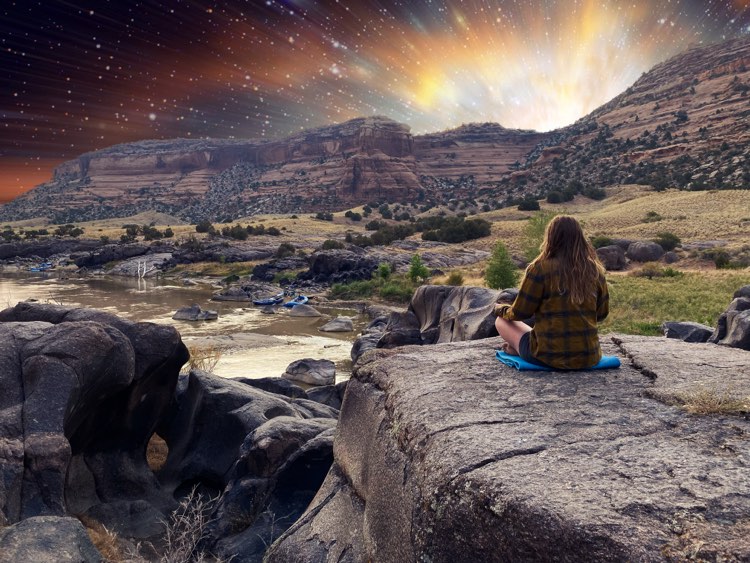 Woman meditates, cosmic landscape.