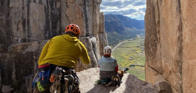 Climbers atop a mountain overlook.