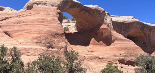 Sandstone arch trail desert landscape.
